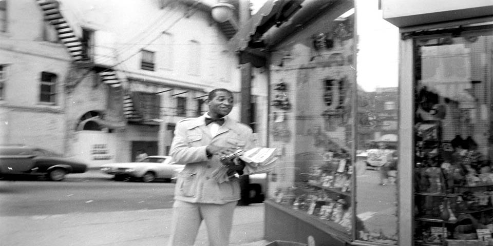HANDING OUT NEWS PAPERS at 5th & Market Streets in Wilmington DE 1975