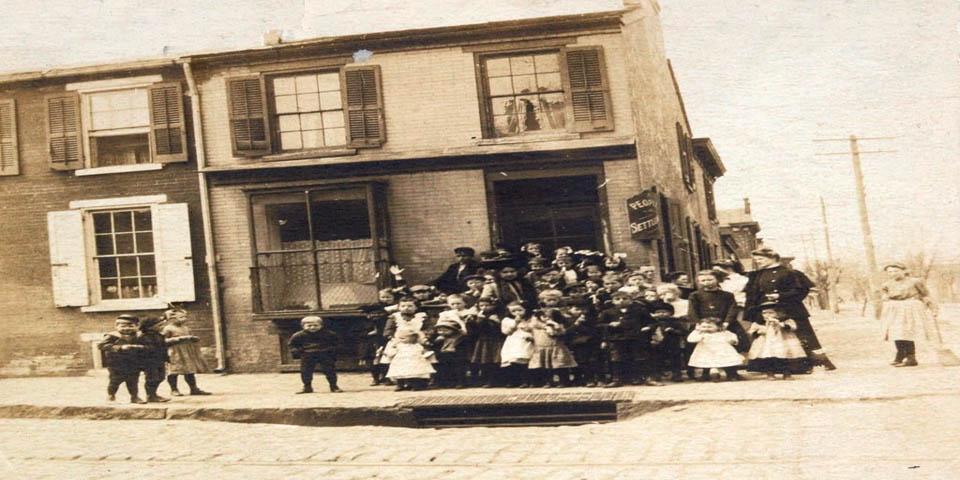 Peoples Settlement Association with a teacher and her students on the East side of Wilmington Delaware circa 1903