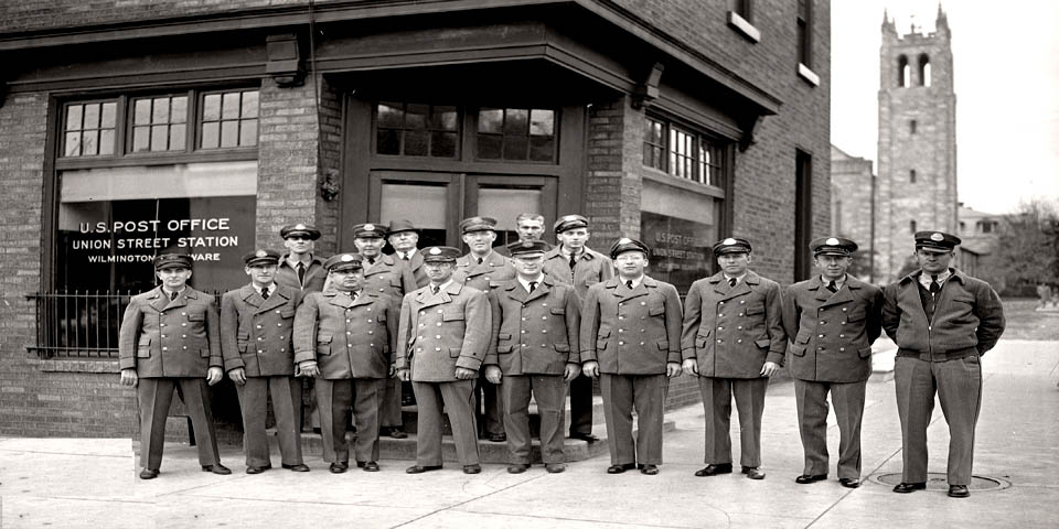 US Postal workers pose in front of the Union Street Post Office in Wilm ington Delaware circa 1940s
